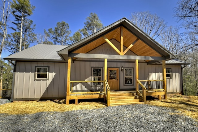 view of front facade featuring metal roof, board and batten siding, and a porch