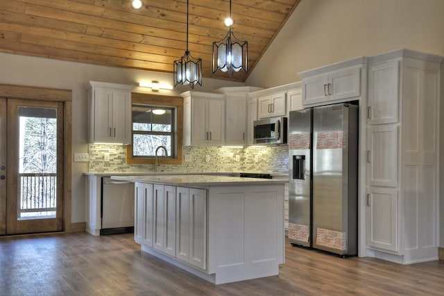 kitchen featuring a notable chandelier, white cabinets, appliances with stainless steel finishes, and plenty of natural light