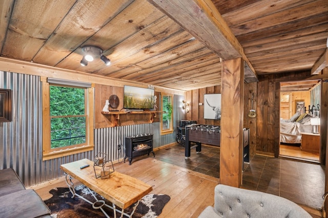 85 Clear Lake Ct, Ellijay, GA 30540 - living area featuring wood ceiling, healthy amount of natural light, wooden walls, a wood stove, and hardwood / wood-style flooring