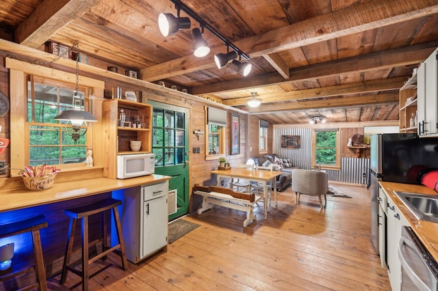 85 Clear Lake Ct, Ellijay, GA 30540 - kitchen featuring wooden ceiling with exposed beams, appliances with stainless steel finishes, open shelves, light wood-style flooring, and wood walls
