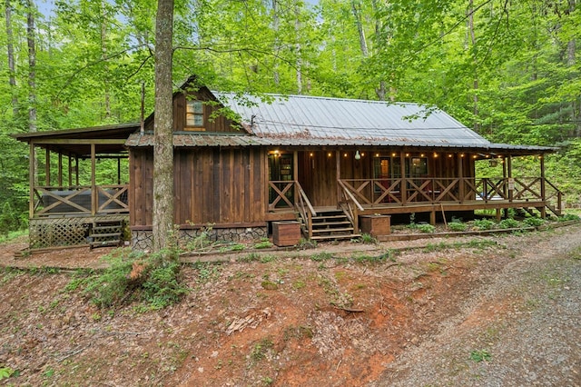 85 Clear Lake Ct, Ellijay, GA 30540 - view of front of house featuring a porch, board and batten siding, a view of trees, and metal roof