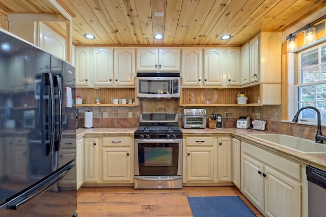 kitchen with wooden ceiling, sink, appliances with stainless steel finishes, and light hardwood / wood-style flooring