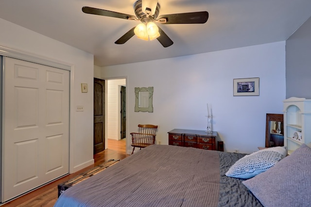 bedroom featuring ceiling fan, a closet, and light wood-type flooring