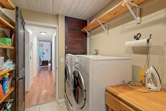 laundry room featuring light hardwood / wood-style floors, washer and clothes dryer, and wooden ceiling