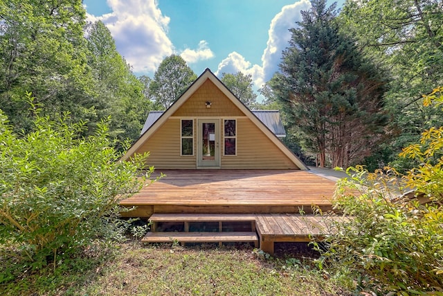 rear view of property featuring a wooden deck