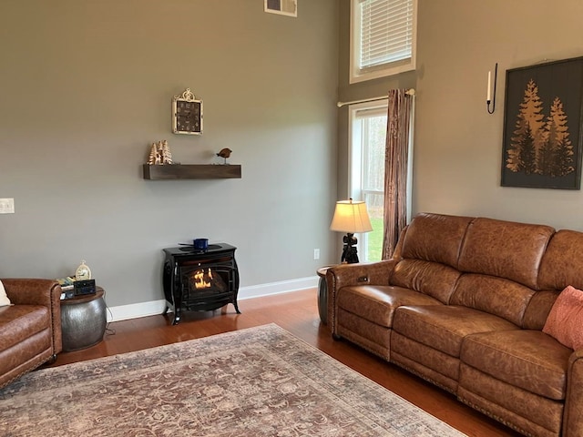 24 Pauls Ct, Blairsville, GA 30512 - living area with visible vents, baseboards, wood finished floors, and a wood stove