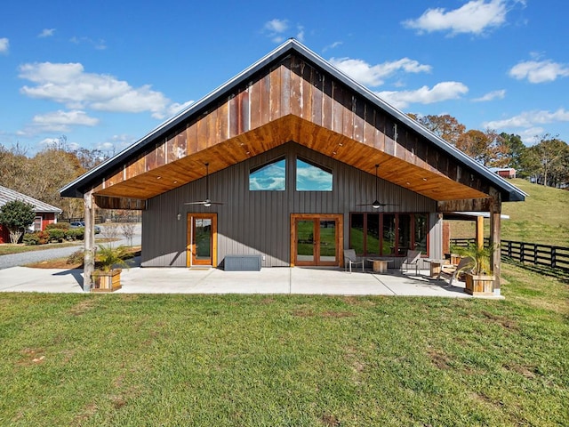 back of house featuring a yard, a patio, and french doors