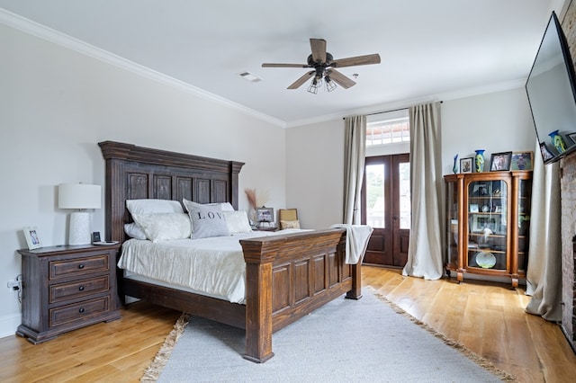 bedroom with light wood-style flooring, visible vents, french doors, and ornamental molding