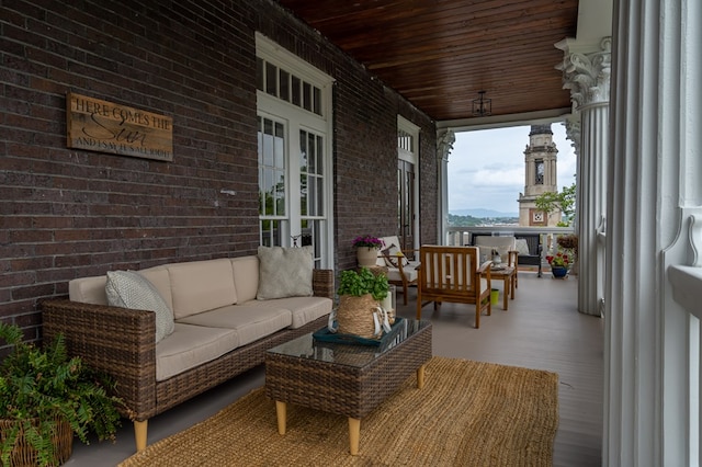 wooden deck featuring a porch and an outdoor hangout area