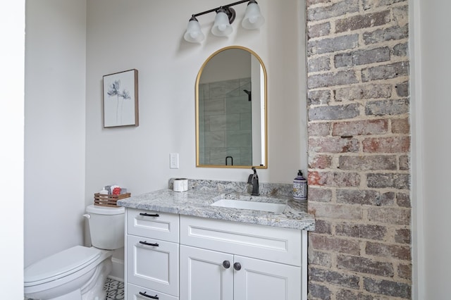 full bath featuring toilet, a shower stall, and vanity