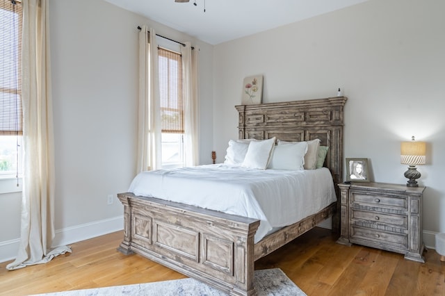 bedroom with light wood-style flooring and baseboards