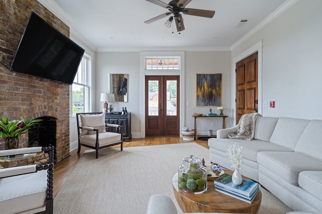 living room with ornamental molding, french doors, visible vents, and light wood-style flooring