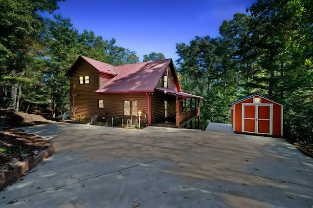 view of home's exterior with a storage shed