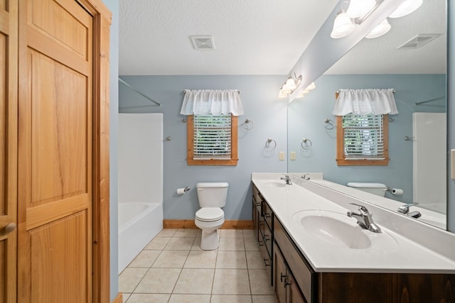 full bathroom featuring vanity, a textured ceiling, bathing tub / shower combination, tile patterned flooring, and toilet