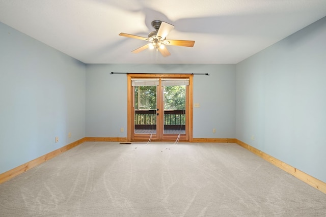 spare room featuring ceiling fan and light colored carpet