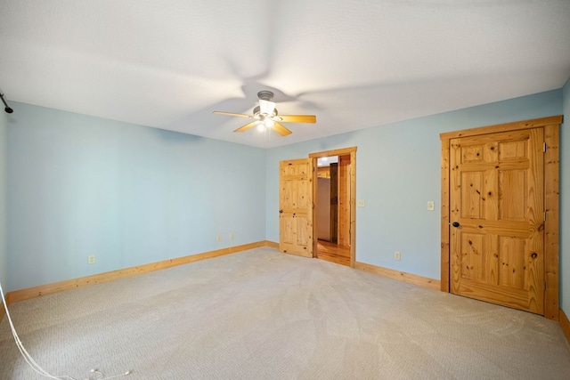 spare room featuring carpet flooring and ceiling fan