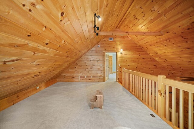 bonus room featuring wood walls, carpet floors, wooden ceiling, and vaulted ceiling