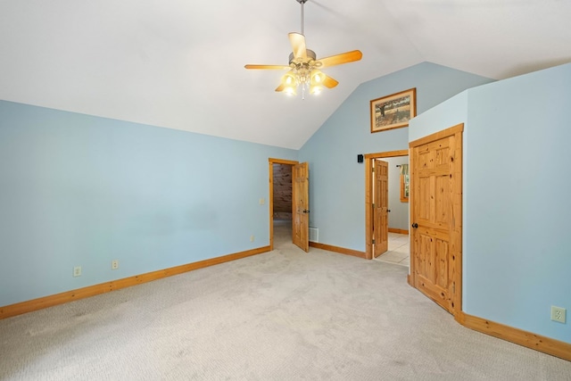 unfurnished bedroom with light carpet, vaulted ceiling, and ceiling fan