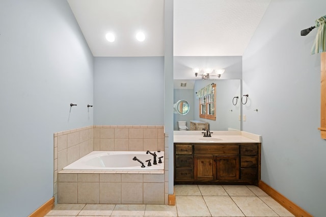 bathroom featuring vanity, tile patterned flooring, a relaxing tiled tub, and vaulted ceiling