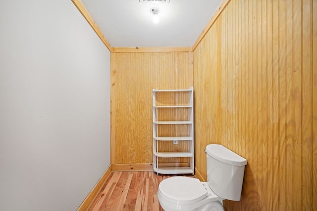 bathroom with toilet and hardwood / wood-style flooring