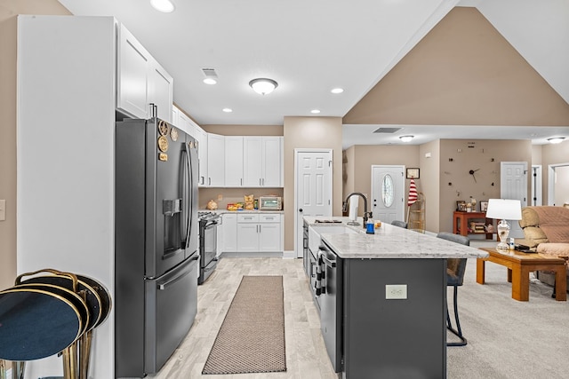 2092 Pleasant Grove Rd, Blairsville, GA 30512 - kitchen with fridge with ice dispenser, white cabinetry, a kitchen bar, a sink, and a kitchen island with sink