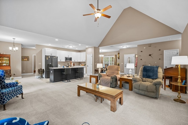 2092 Pleasant Grove Rd, Blairsville, GA 30512 - living room with high vaulted ceiling, a chandelier, light colored carpet, a ceiling fan, and baseboards