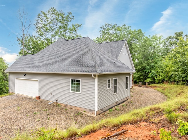 2092 Pleasant Grove Rd, Blairsville, GA 30512 - view of side of property featuring a shingled roof, dirt driveway, crawl space, and a garage