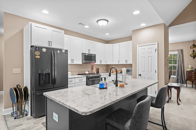 2092 Pleasant Grove Rd, Blairsville, GA 30512 - kitchen featuring appliances with stainless steel finishes, a kitchen bar, baseboards, light stone counters, and white cabinets