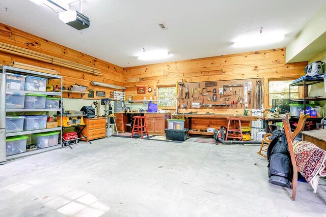 bedroom with beamed ceiling, access to exterior, wooden walls, hardwood / wood-style floors, and ceiling fan