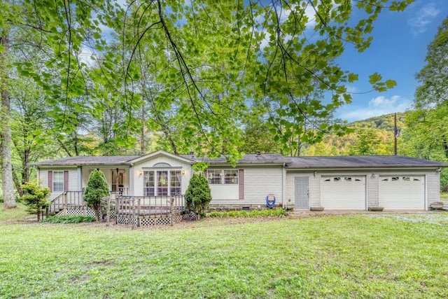 single story home featuring a garage and a front lawn