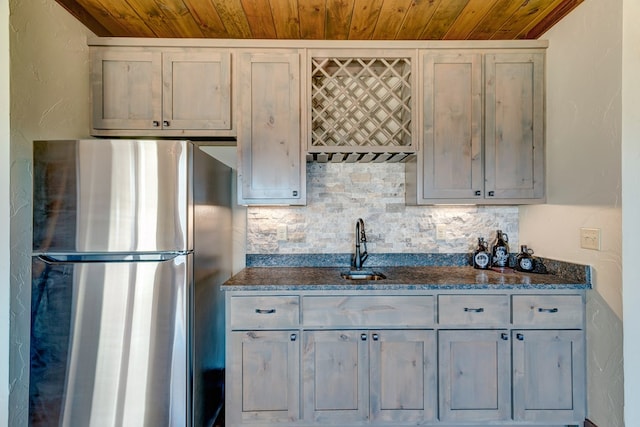 370 High Ridge Rd, Epworth, GA 30513 - kitchen featuring freestanding refrigerator, wood ceiling, a sink, tasteful backsplash, and dark stone countertops