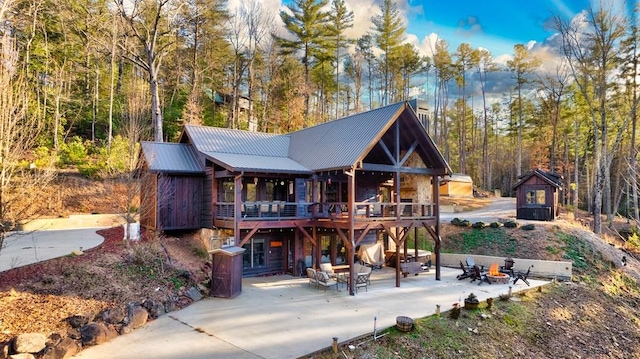 rear view of house with a patio area and a wooden deck