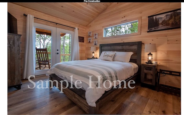 bedroom with multiple windows, lofted ceiling, wooden walls, and french doors