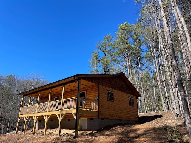 view of side of property featuring a wooden deck