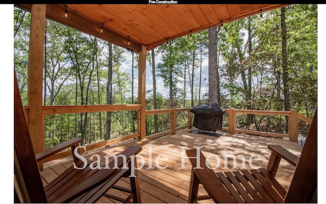 wooden deck with a grill