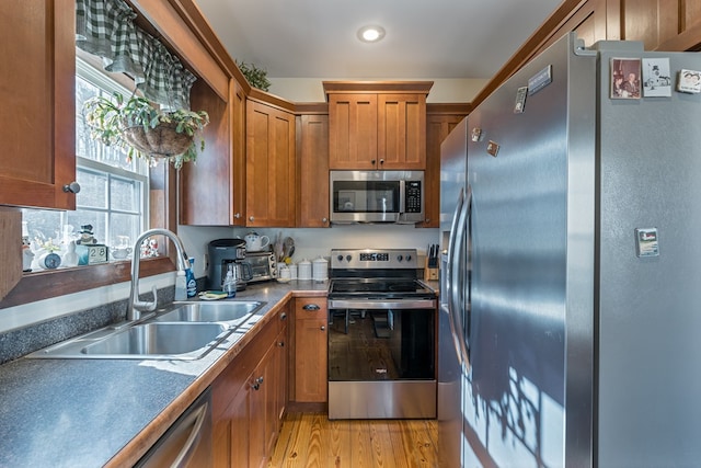 kitchen featuring sink, stainless steel appliances, and light hardwood / wood-style floors