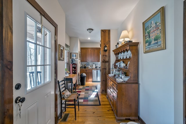 doorway to outside with wood-type flooring