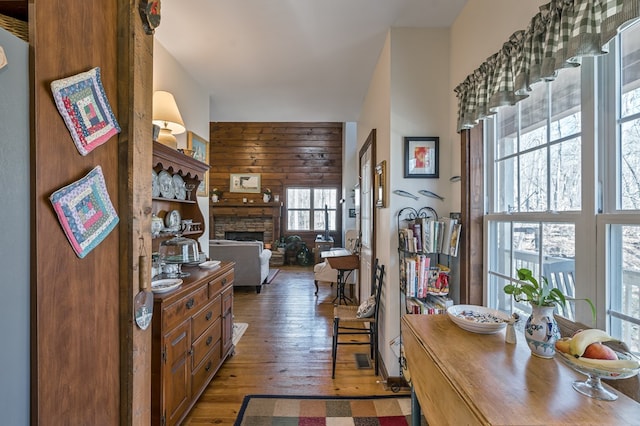 interior space with hardwood / wood-style flooring, a fireplace, and wood walls