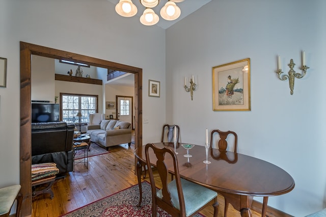 dining room with hardwood / wood-style floors and an inviting chandelier