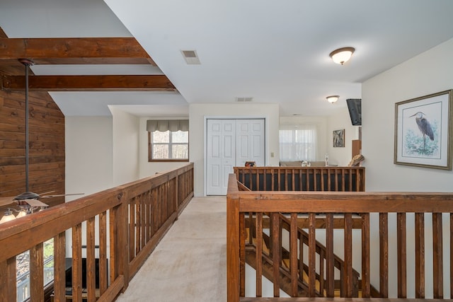 hallway featuring beamed ceiling