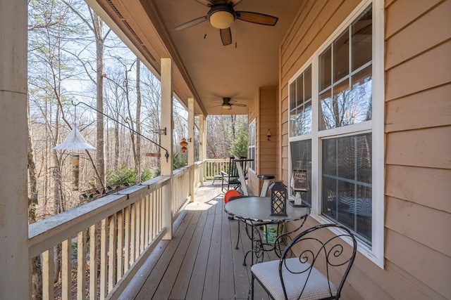 deck with ceiling fan and a porch