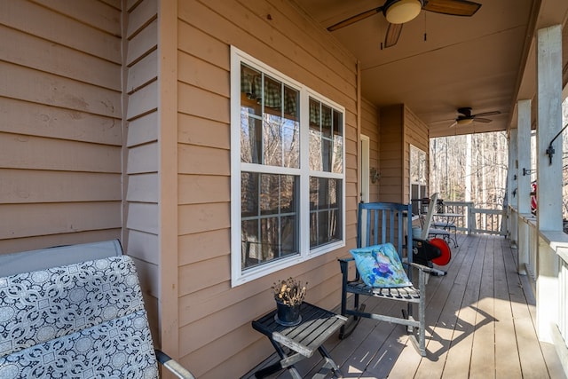 wooden deck with a porch and ceiling fan