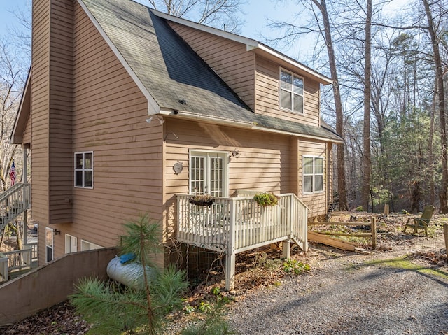 view of property exterior with a wooden deck