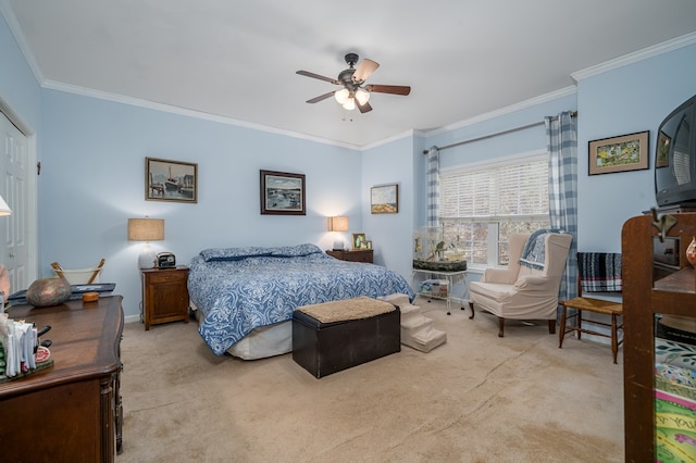 carpeted bedroom featuring crown molding and ceiling fan