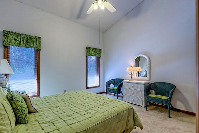 carpeted bedroom featuring lofted ceiling and ceiling fan