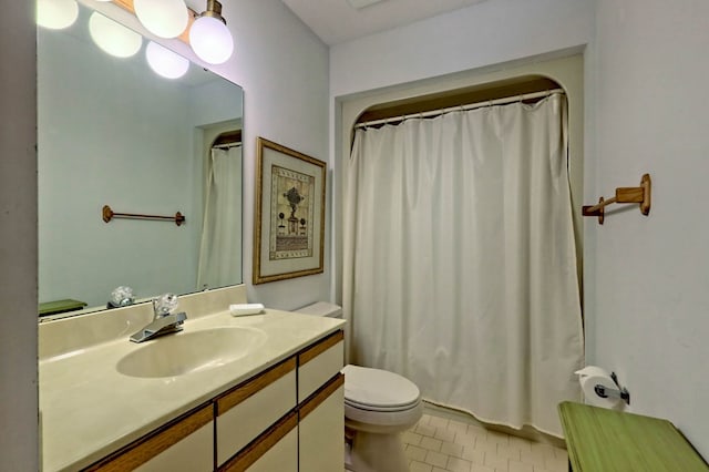 bathroom featuring tile patterned floors, vanity, toilet, and a shower with shower curtain