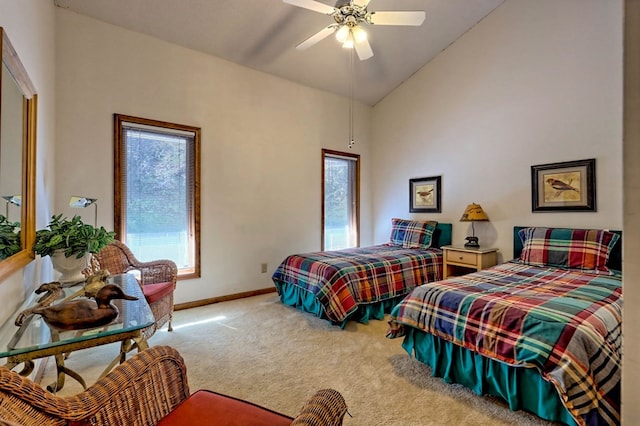 carpeted bedroom featuring high vaulted ceiling and ceiling fan