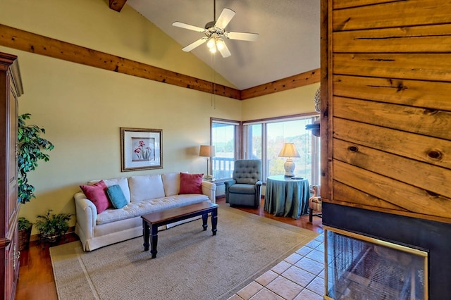 living room featuring light tile patterned flooring, ceiling fan, and high vaulted ceiling