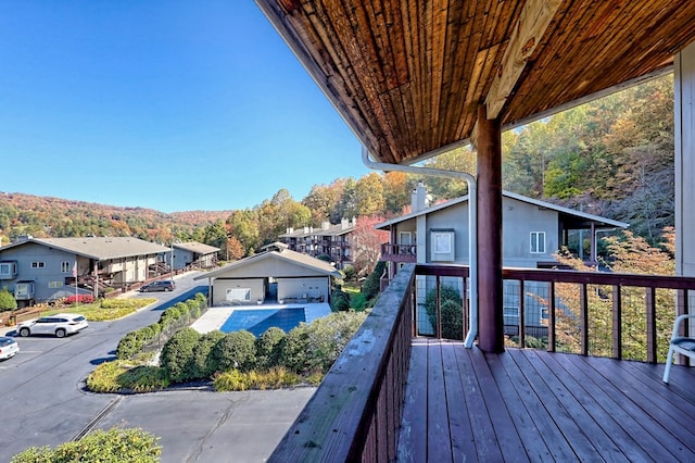 wooden terrace with a garage and a mountain view