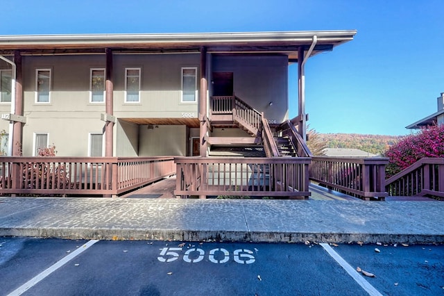 back of property featuring a wooden deck